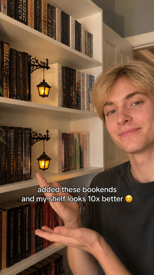 Collector pointing at lantern bookends on his shelf